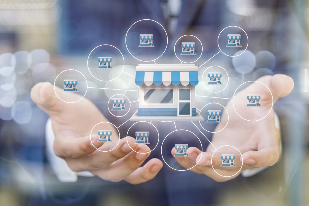 Franchise marketing system in the hands of a businessman on a blurred background.