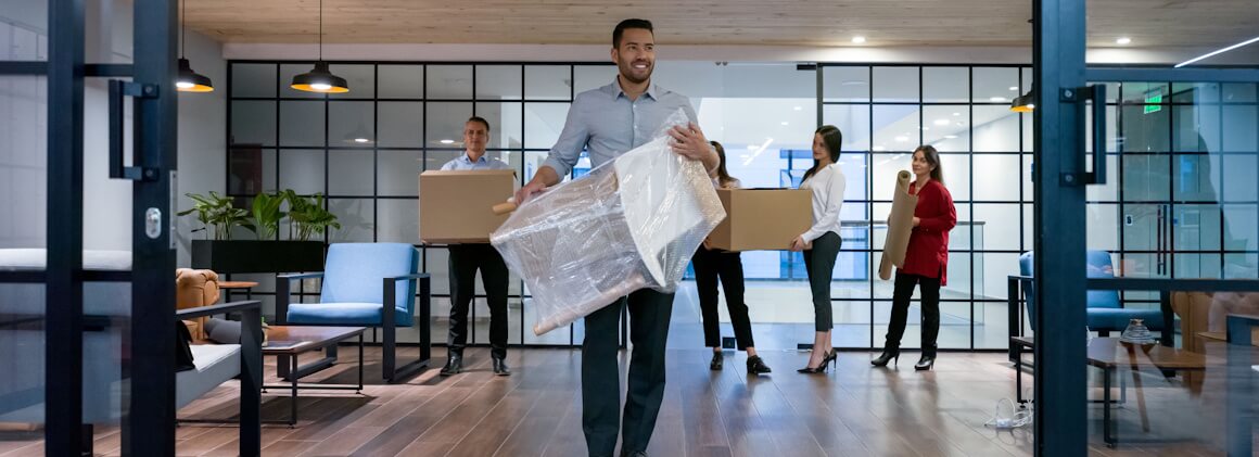picture of young professionals moving into a new office space that they rented